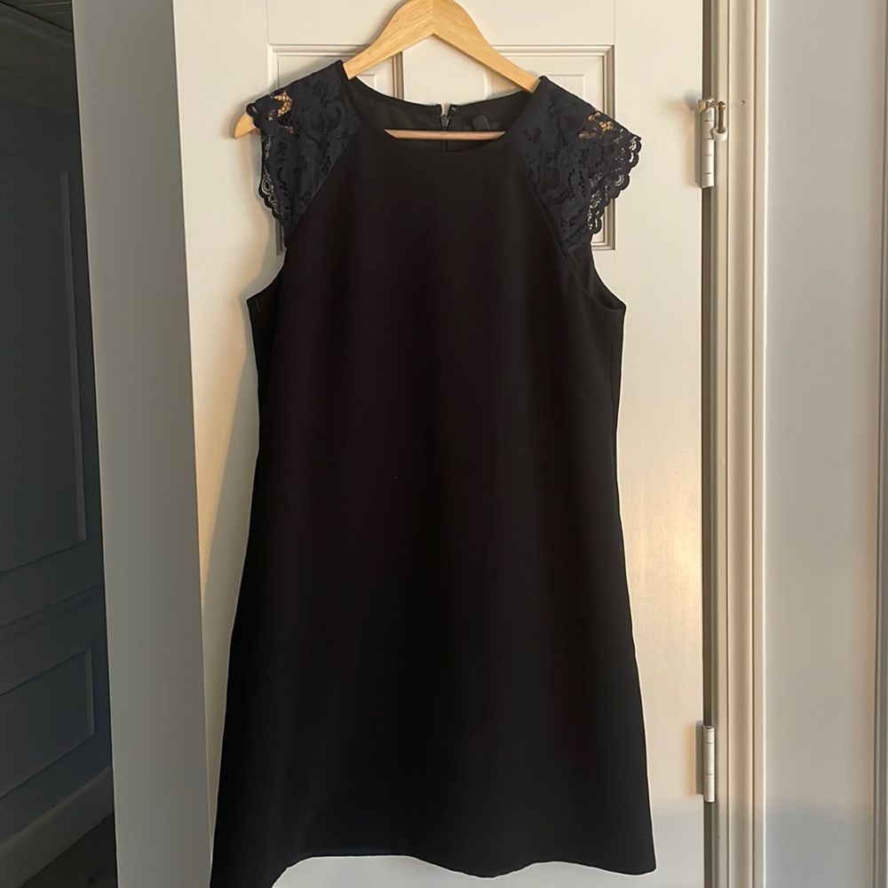 Black shift dress with navy blue lace cap sleeves.